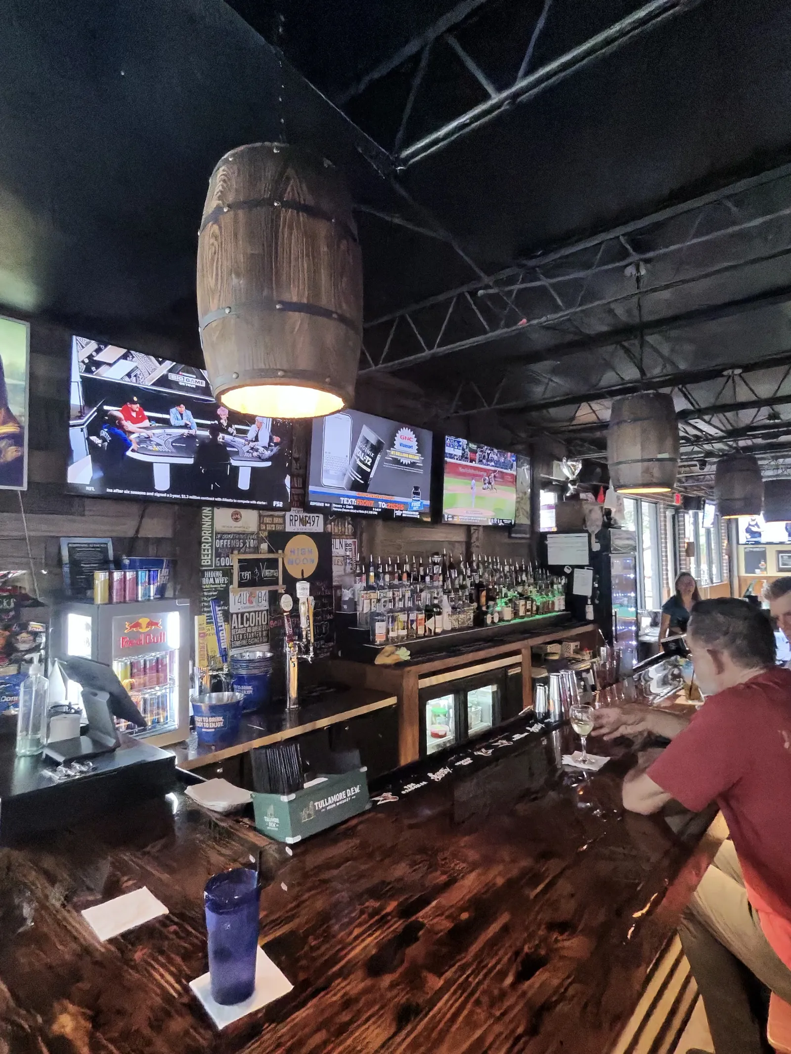 Whiskey barrel pendant lights over the back bar at Locals Only