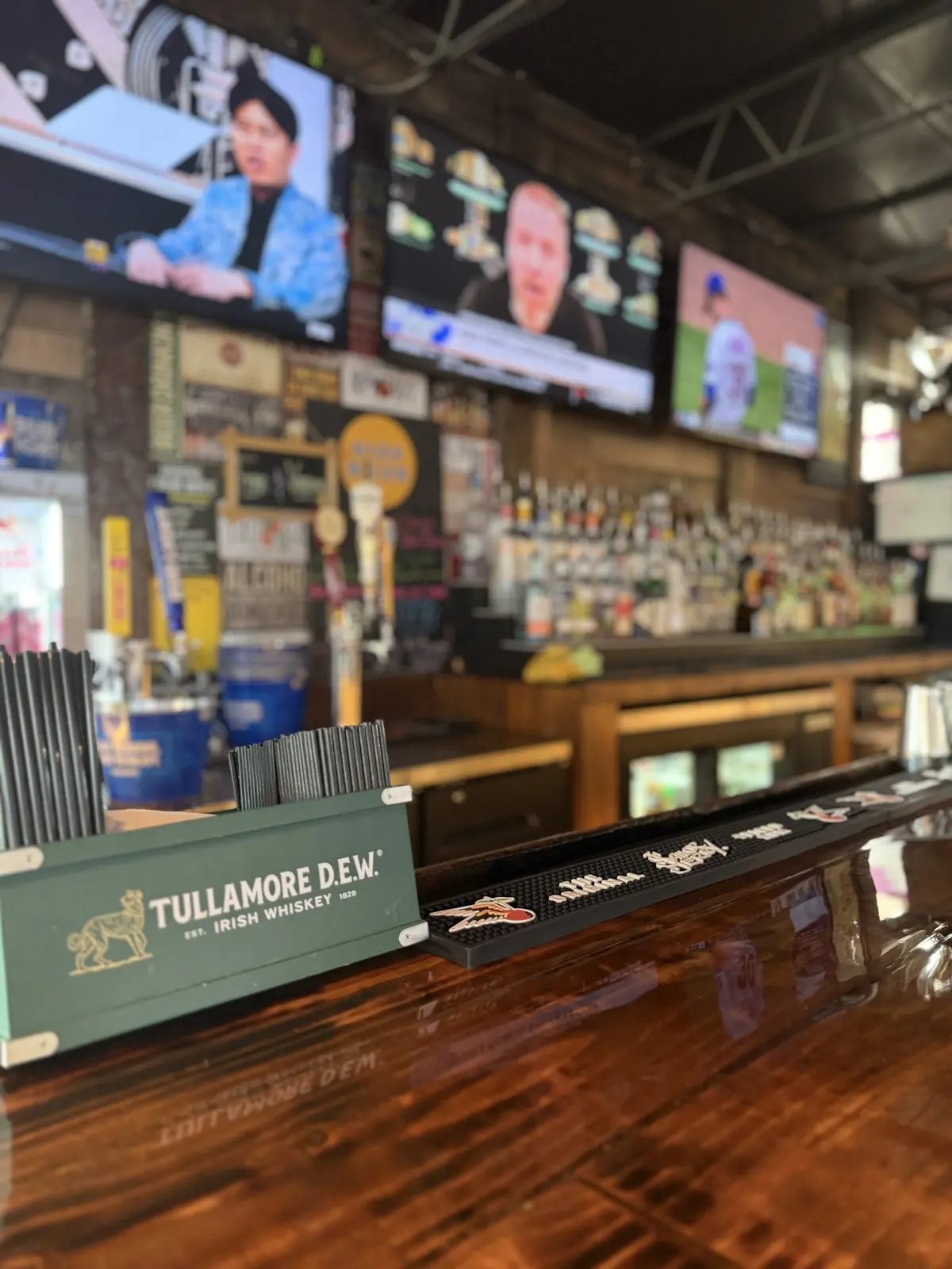 Bar top, taps, and bottles inside Locals Only Neighborhood Bar