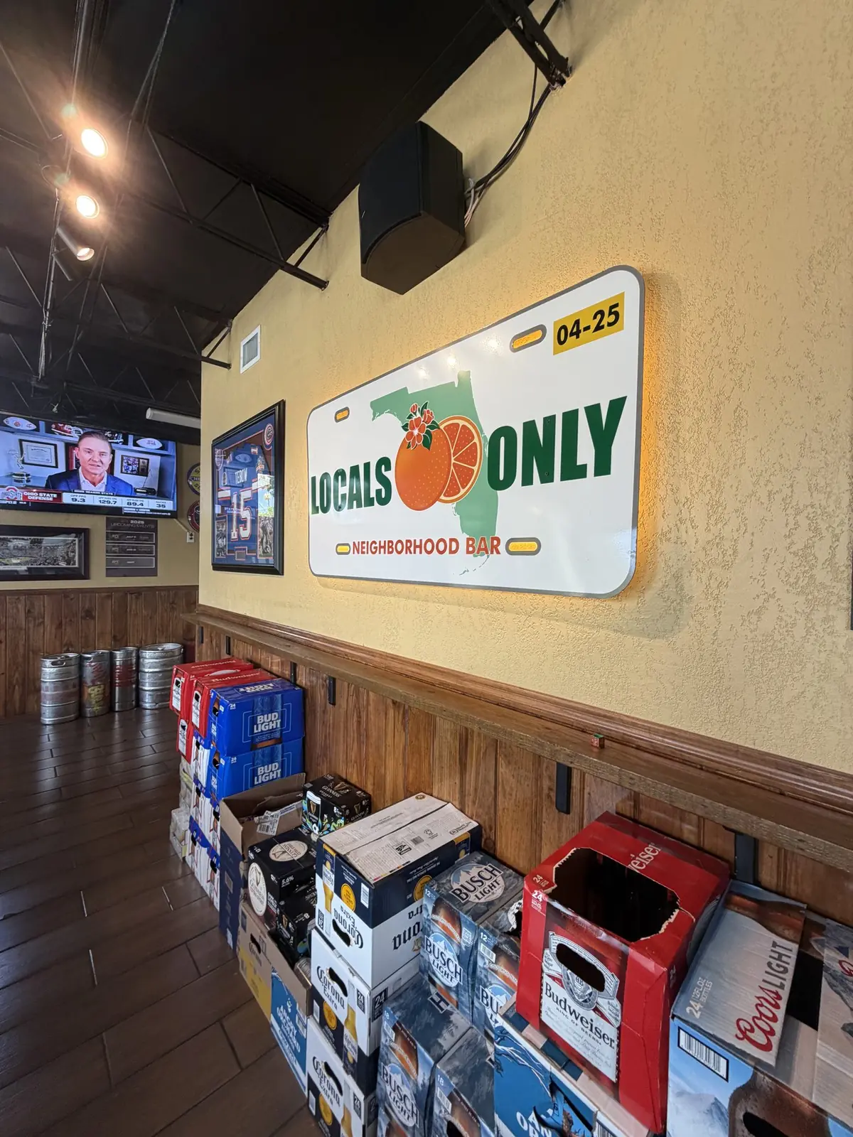 Locals Only Neighborhood Bar license plate sign inside the bar