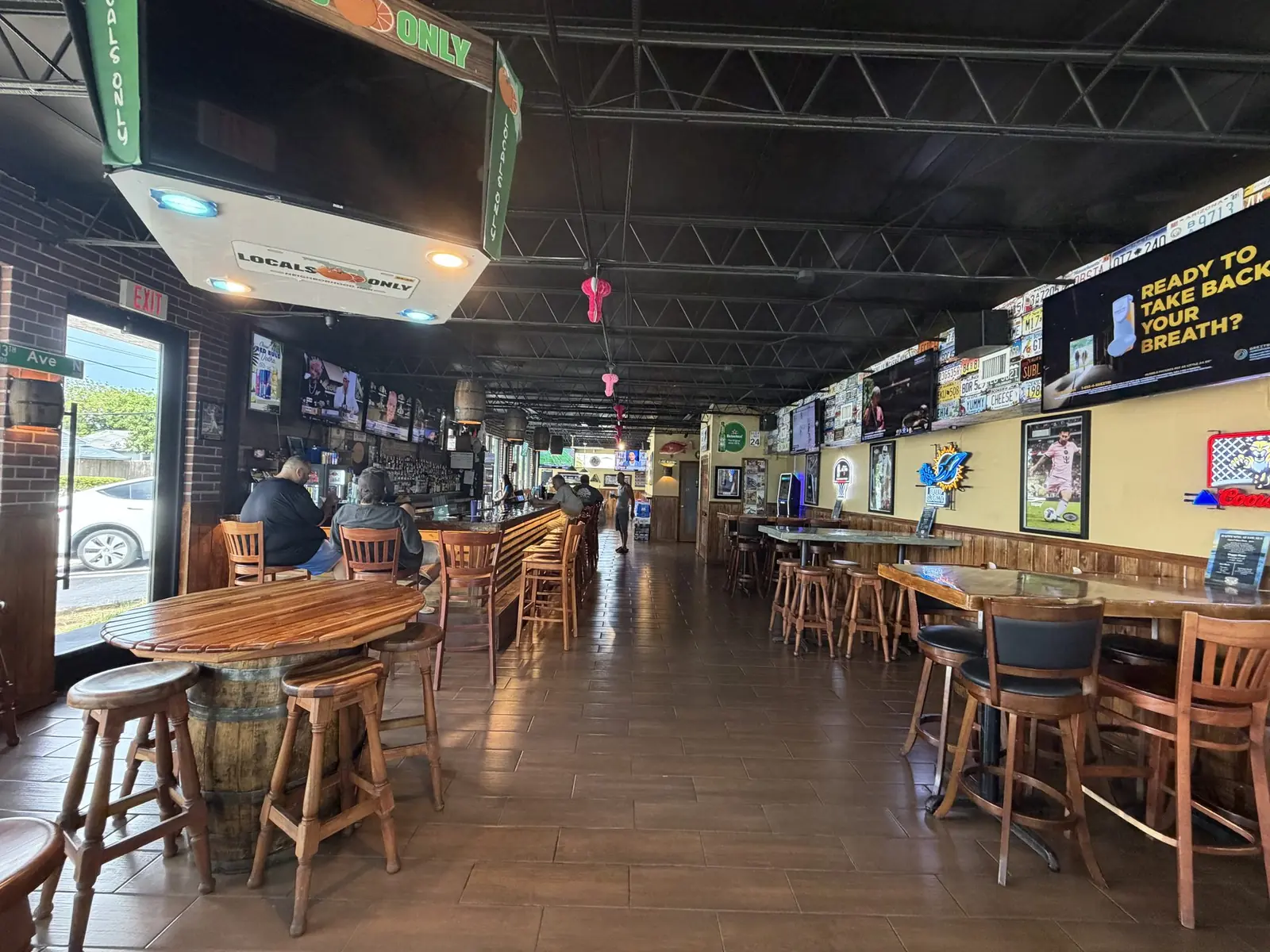 Guests seated at the bar rail inside Locals Only